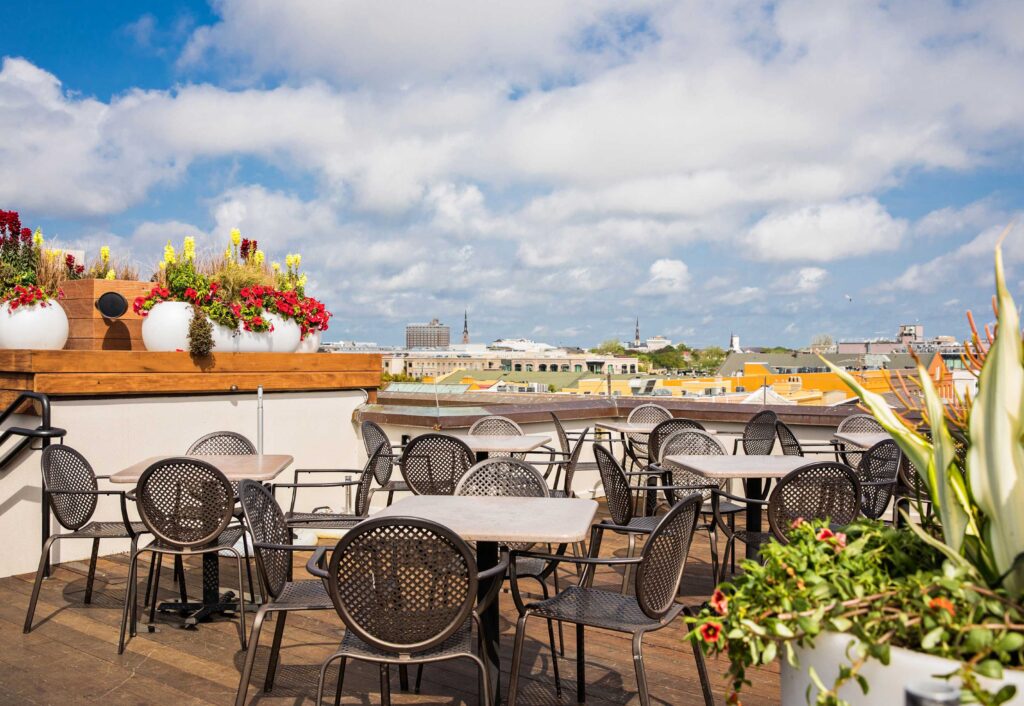 Rooftop dining area surrounded by views and plants