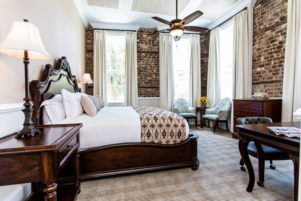 Hotel room with exposed brick and furnishings