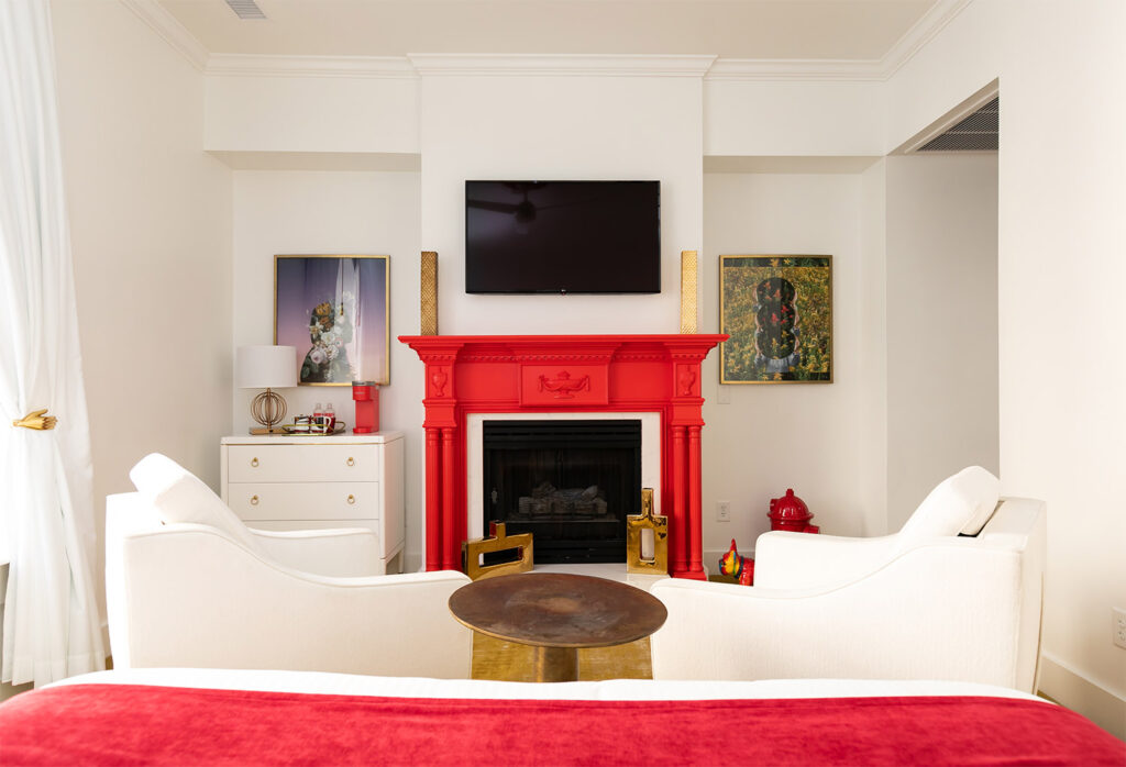 Hotel room with a red fireplace and a wall mounted television