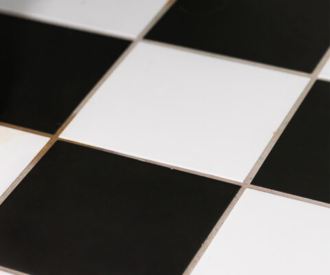 close up photo of black and white tiled floor