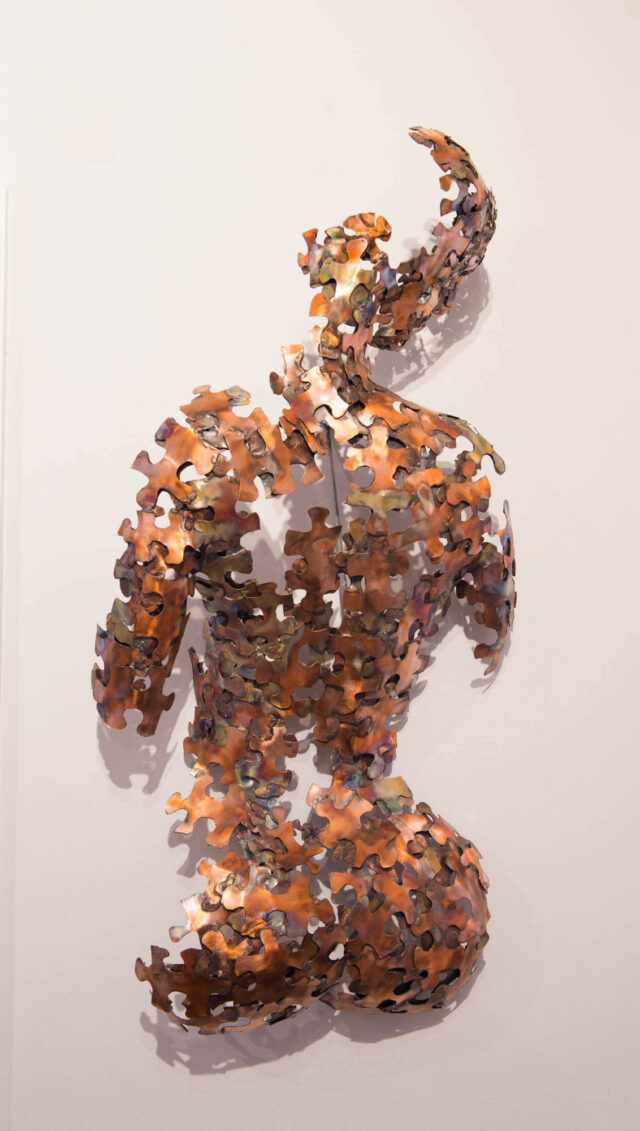 Sculpture of a torso using puzzle pieces