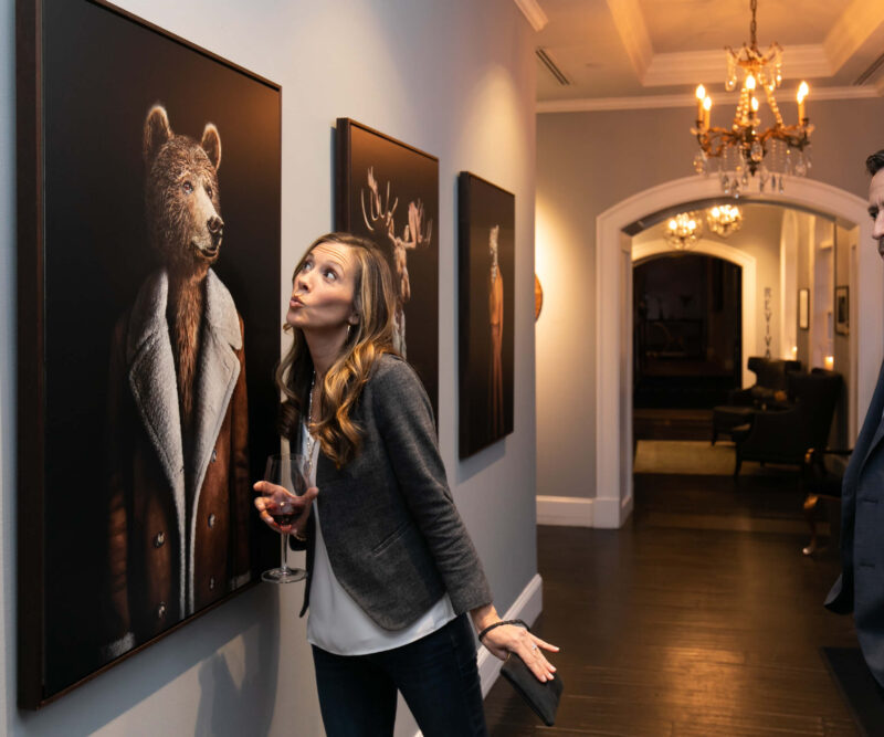 Woman eyeing a portrait of a bear
