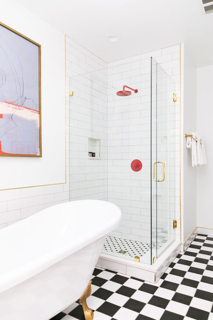 Brightly painted bathroom with checkerboard tile, bathtub and walk in shower