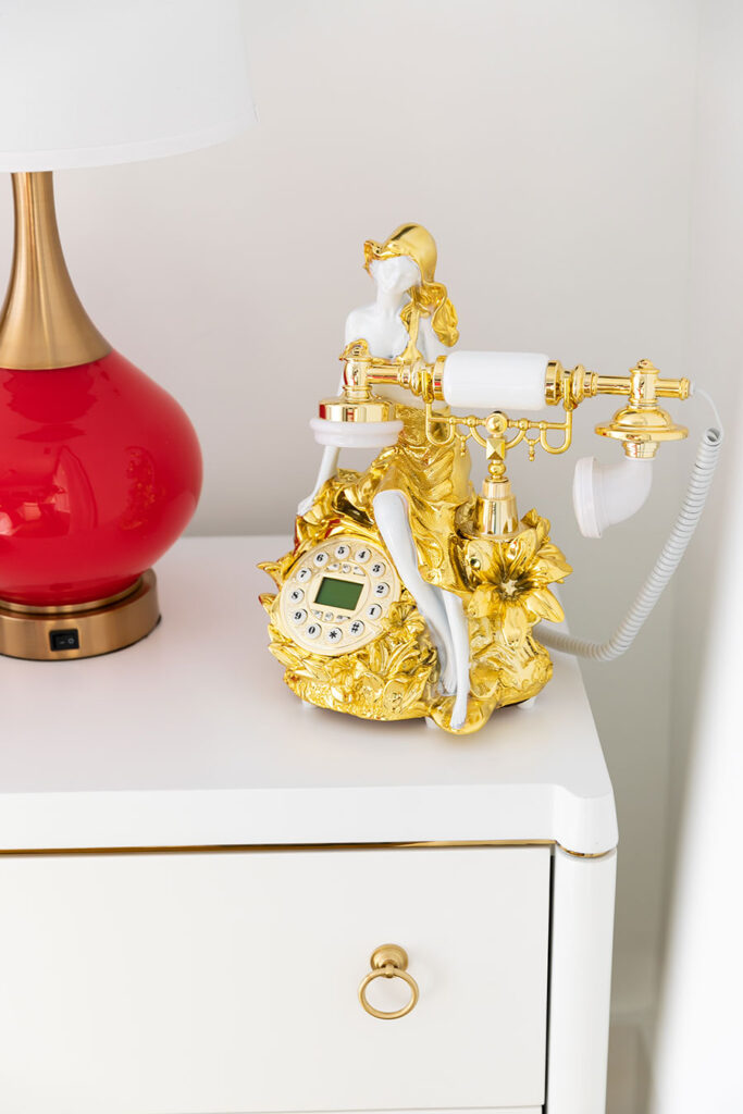Gold telephone set on a bedside table