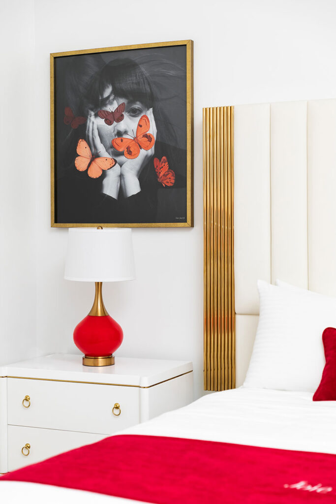 Bedside table and lamp sitting below painting