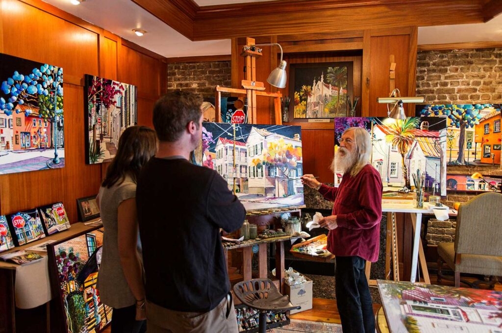 Artist painting and talking with onlookers